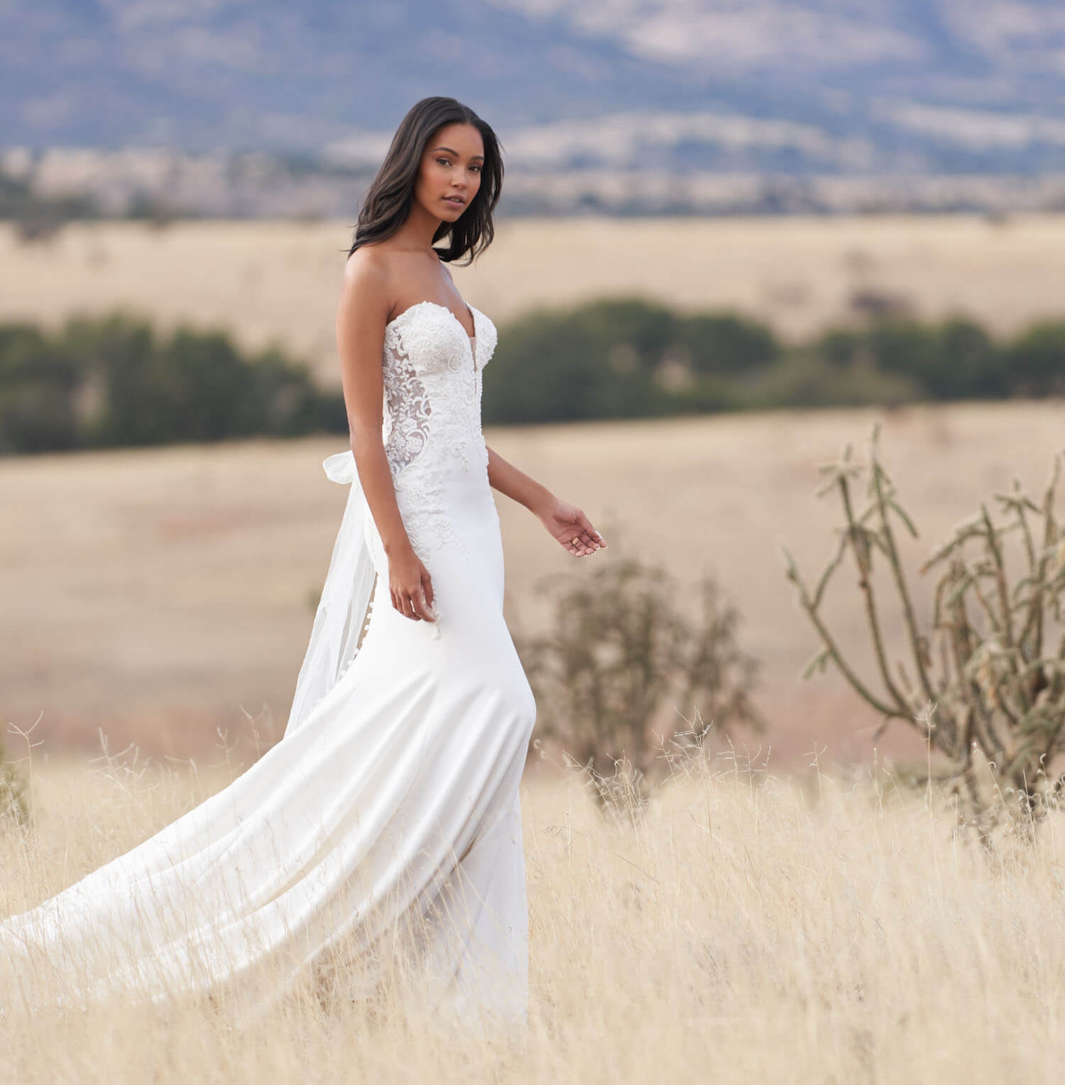 Model wearing a white gown. Mobile image