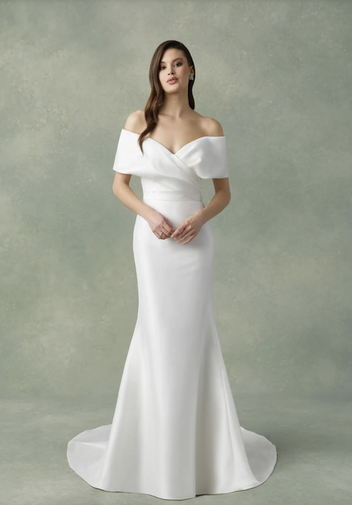 Model wearing a white gown. Mobile Image